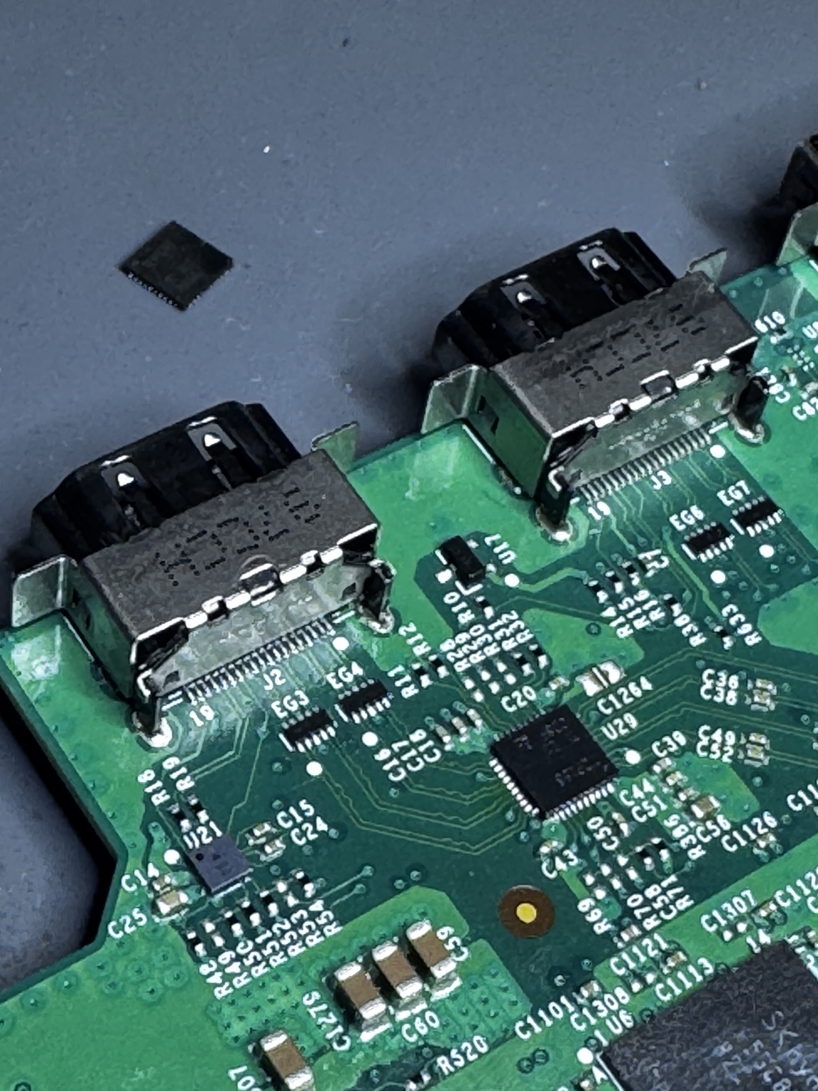 Close view of two board-mounted ports on a game console motherboard