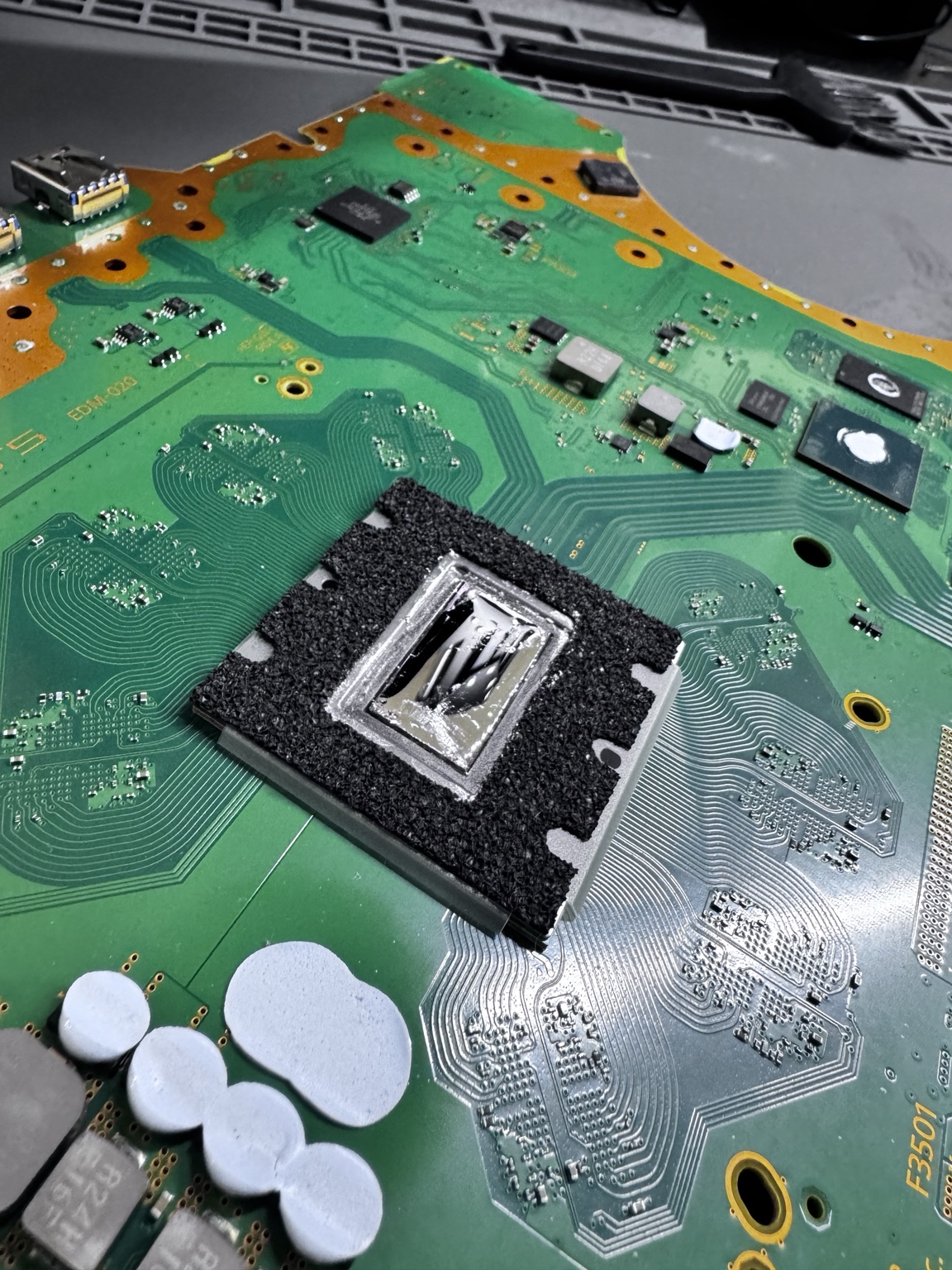 PlayStation 5 motherboard with the APU exposed during service