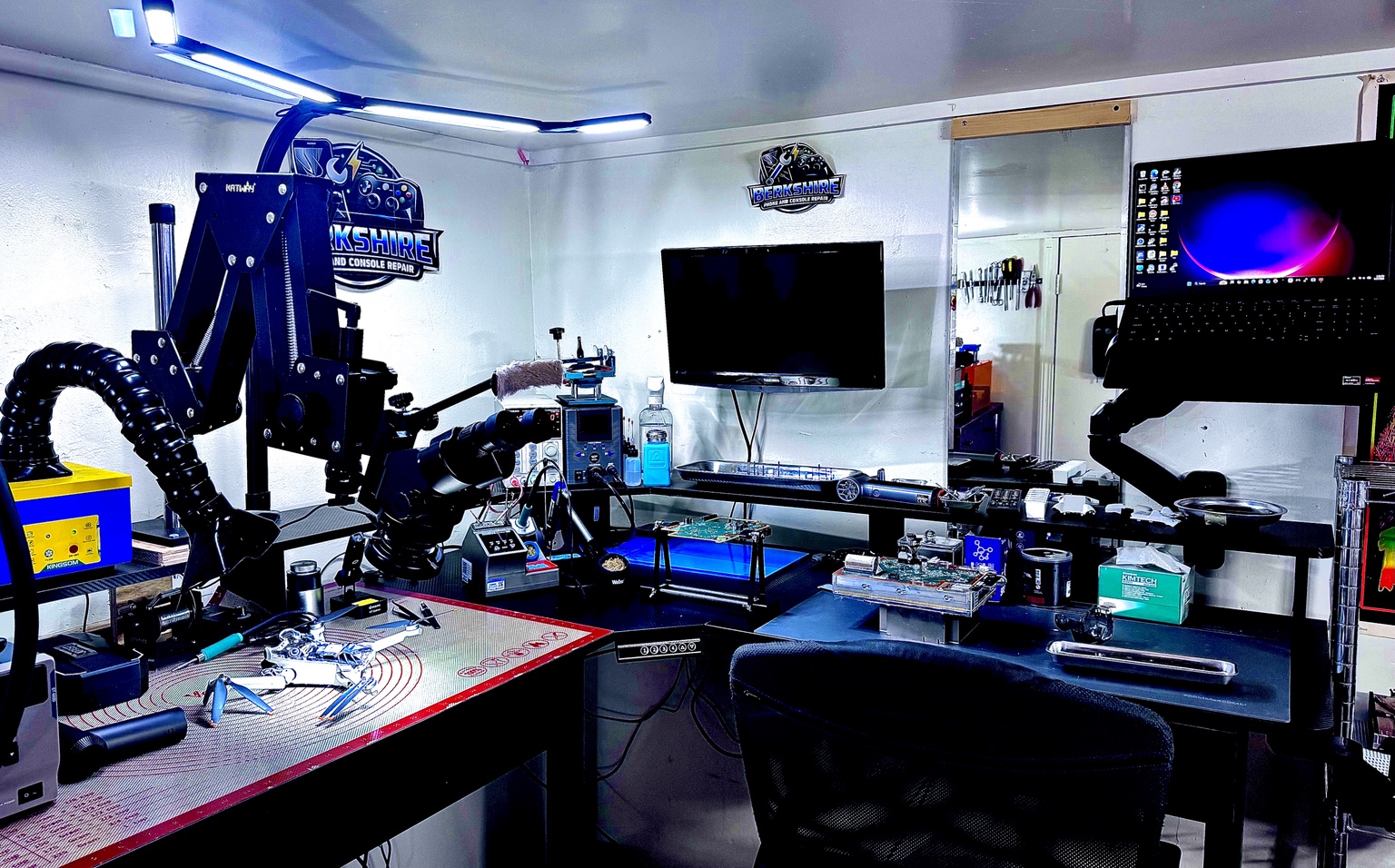 Berkshire Phone and Console Repair workspace with microscopes, soldering equipment, diagnostic tools and repair benches